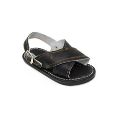 Kid's handmade black genuine leather Mexican sandals featuring a classic two-strap design, adjustable buckle heel strap, cushioned leather footbed, and durable rubber outsole handcrafted in Mexico.