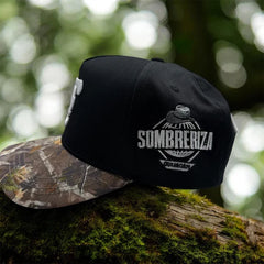 Side profile of JG Hats Culiacán Sombreriza snapback showing embroidered Sombreriza Culiacán patch and camouflage brim.