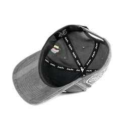 Gray cap with black interior and visible branding on a white background