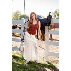 Women's rust button-up corset style western top with lace trim styled with cream lace skirt
