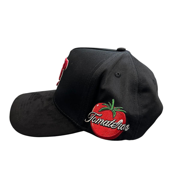 Side view of black Tomateros snapback hat with embroidered tomato logo artwork