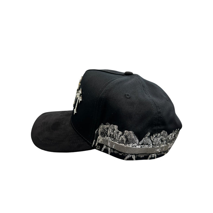 Side view of black JG snapback hat with embroidered Last Supper-inspired artwork